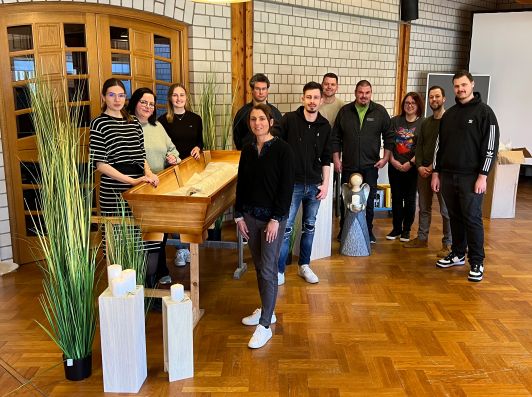 Lehrgangsteilnehmer am offenen Sarg stehend